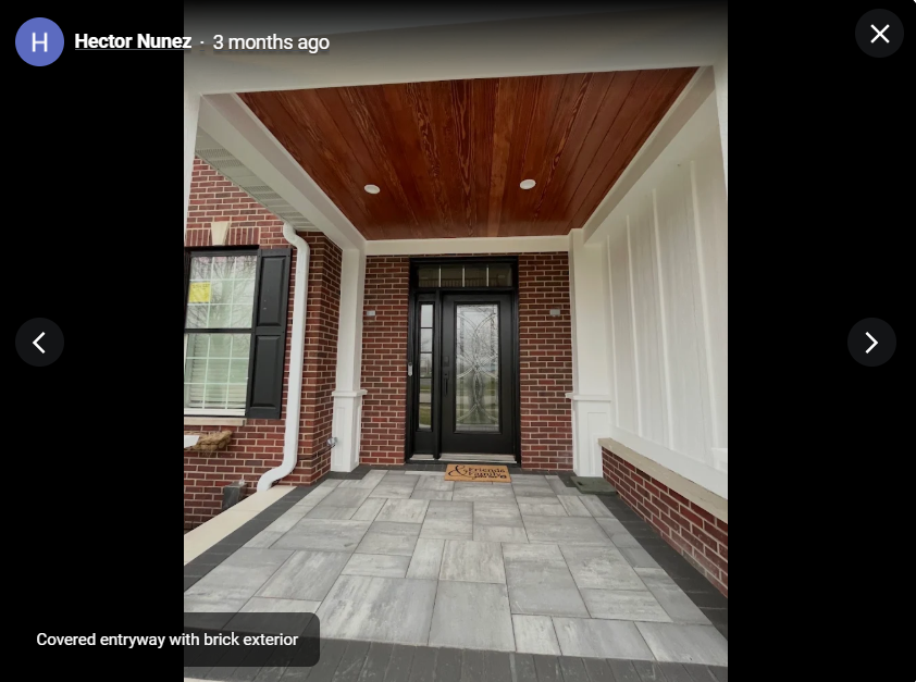 Covered brick entryway with wood ceiling and tiled floor