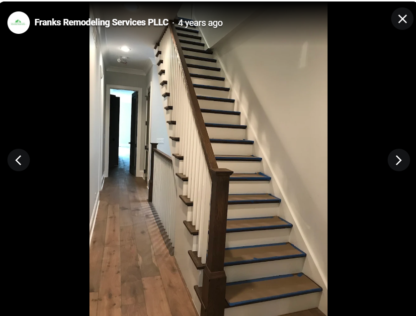 Finished interior staircase with wood handrail and hardwood flooring